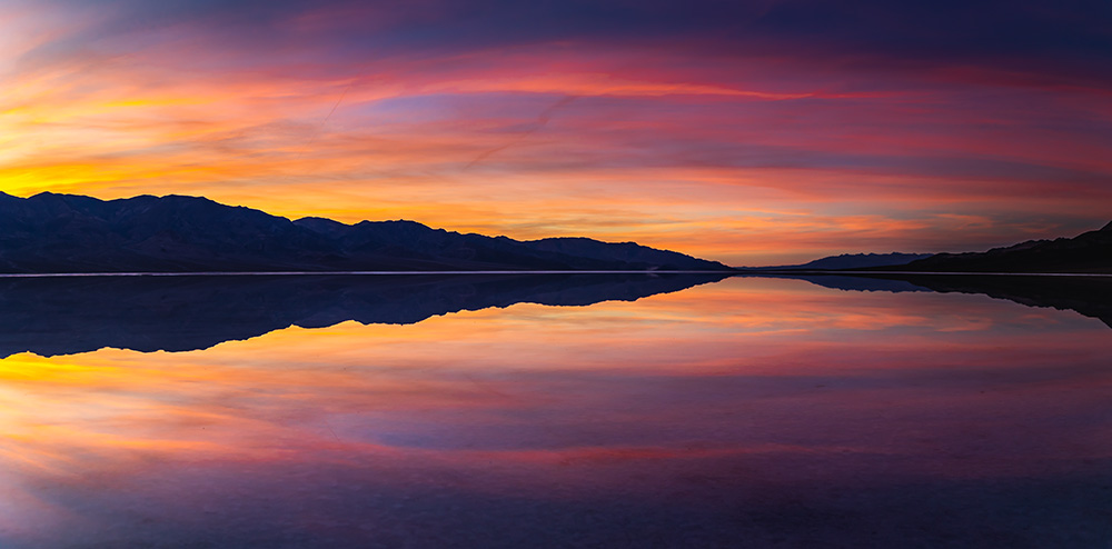 One doesn’t often have a chance to feel like a saint. Unless it’s gliding on a surface of a many-mile wide but just two-inch deep lake. What typically is vast salt flats of the lowest point in the North America, recently turned into ephemeral lake due to the unprecedented rainfall in the park the past 6 months. Previously it happened almost 20 years ago. Nobody knew how long it would last this time. The Death Valley is undoubtedly full of life. The quintessence of its fleeting aspect.