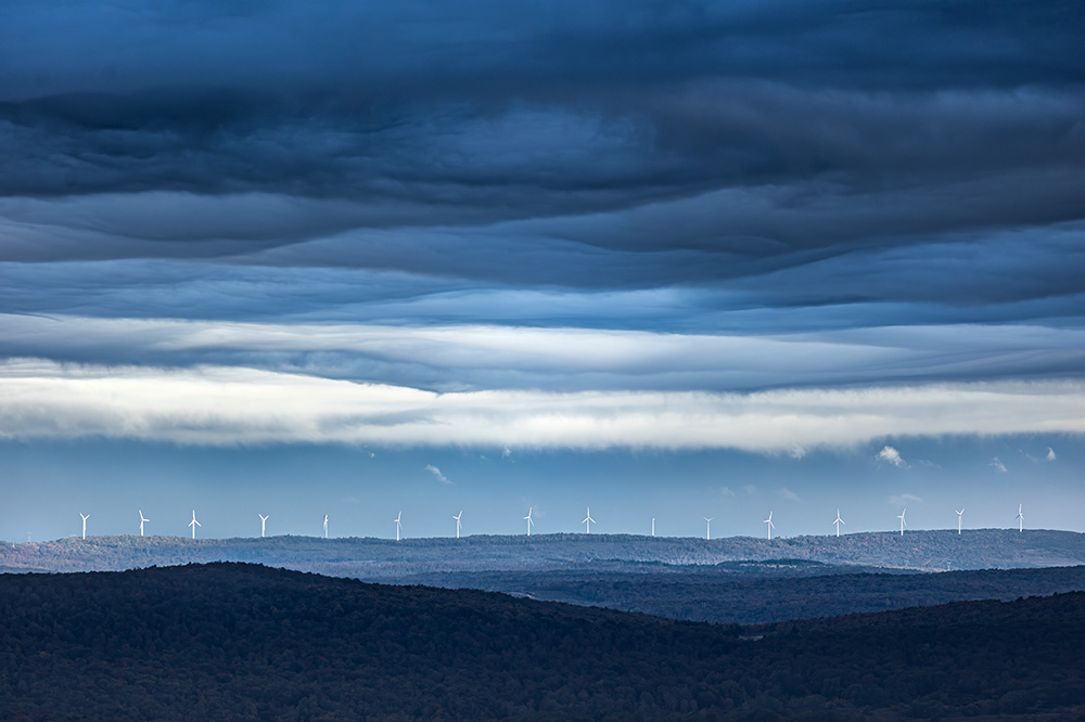 The spectrum of reactions from people viewing this photo is as wide as it gets. Some appreciate the composition; others are upset by wind turbines “ruining” the landscape. Still others celebrate clean energy. The point of this picture? Only you decide.