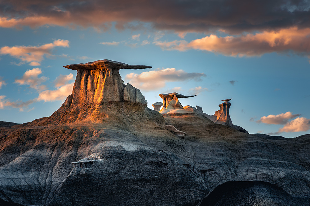 I spent a couple of hours near these formations in the Bisti Badlands, waiting for the perfect light for the picture and carefully climbing around the formations. While blue hour often brings a marvelous glow to the terrain in places like this, ironically the best picture from that evening was taken long before sunset, right from the trail below.