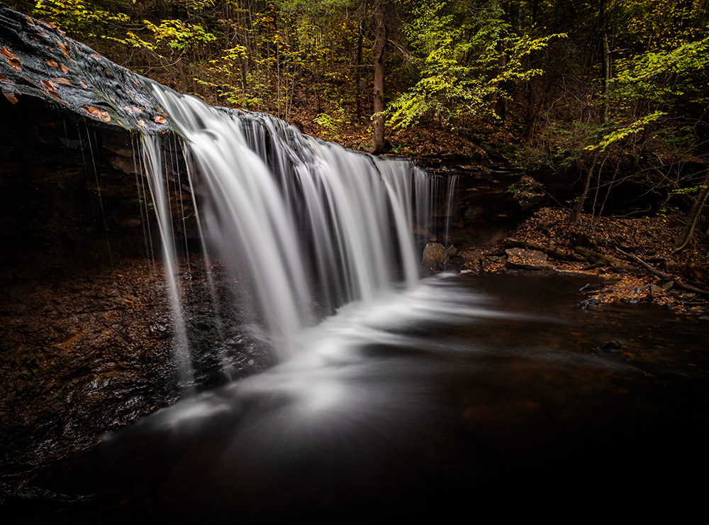 After almost discarding this photo initially, over time I developed a sort of acquired taste for it. The strong leading lines, minimalism, and silky water texture make this picture different from many other waterfalls I've shot.